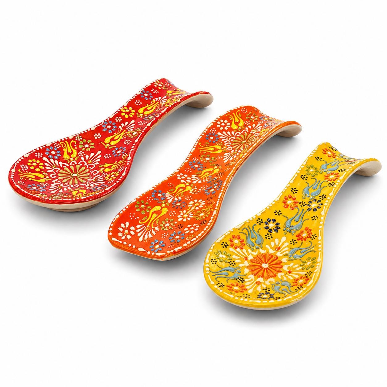 Three warm-color hand-painted floral ceramic spoon rests
