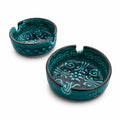 Set of two teal glazed ceramic ashtrays with embossed patterns