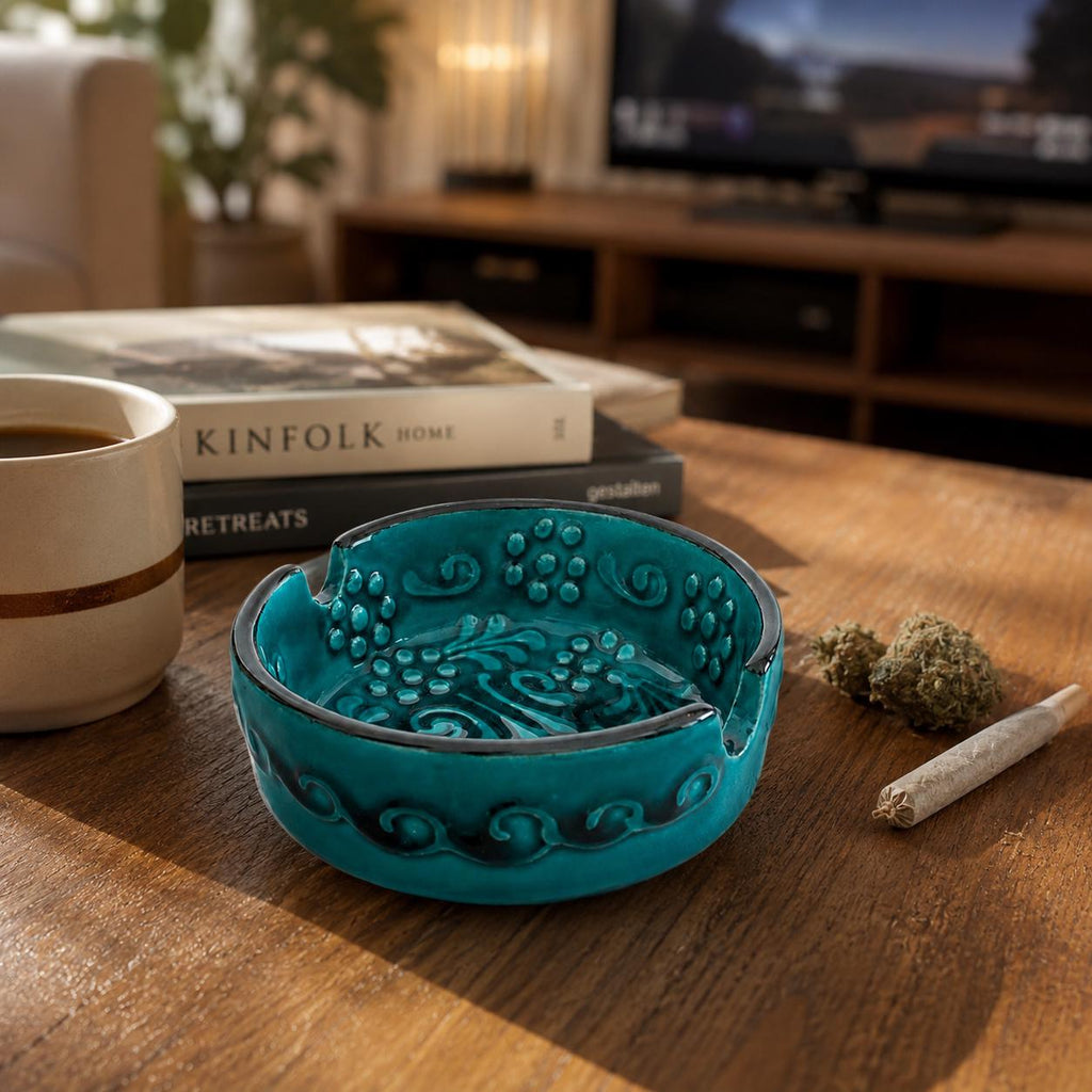 Teal glazed ceramic ashtray with raised floral relief