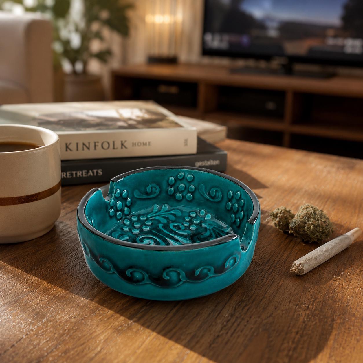 Teal glazed ceramic ashtray with raised floral relief