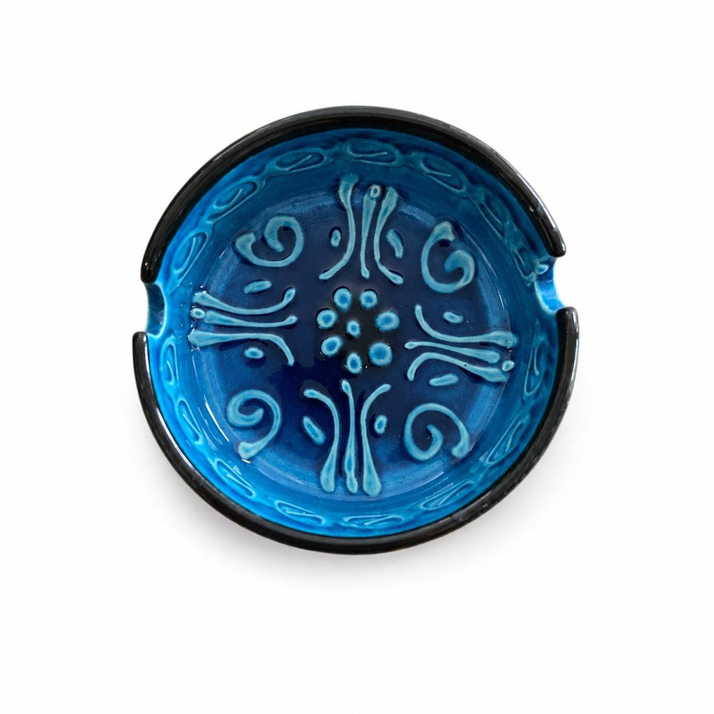 Blue glazed ceramic ashtray with raised floral relief
