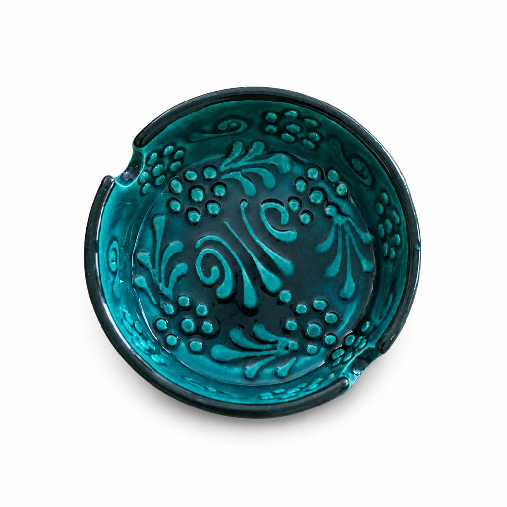 Close view of the teal glaze and embossed ceramic pattern