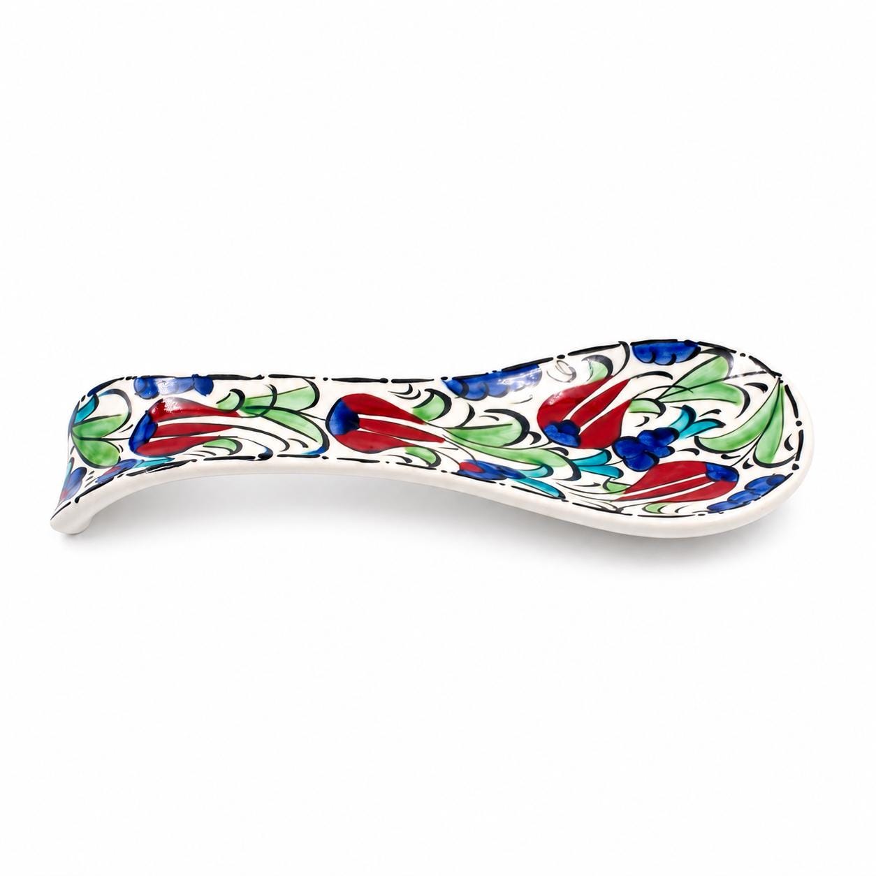 Angled view of the elongated floral ceramic spoon rest