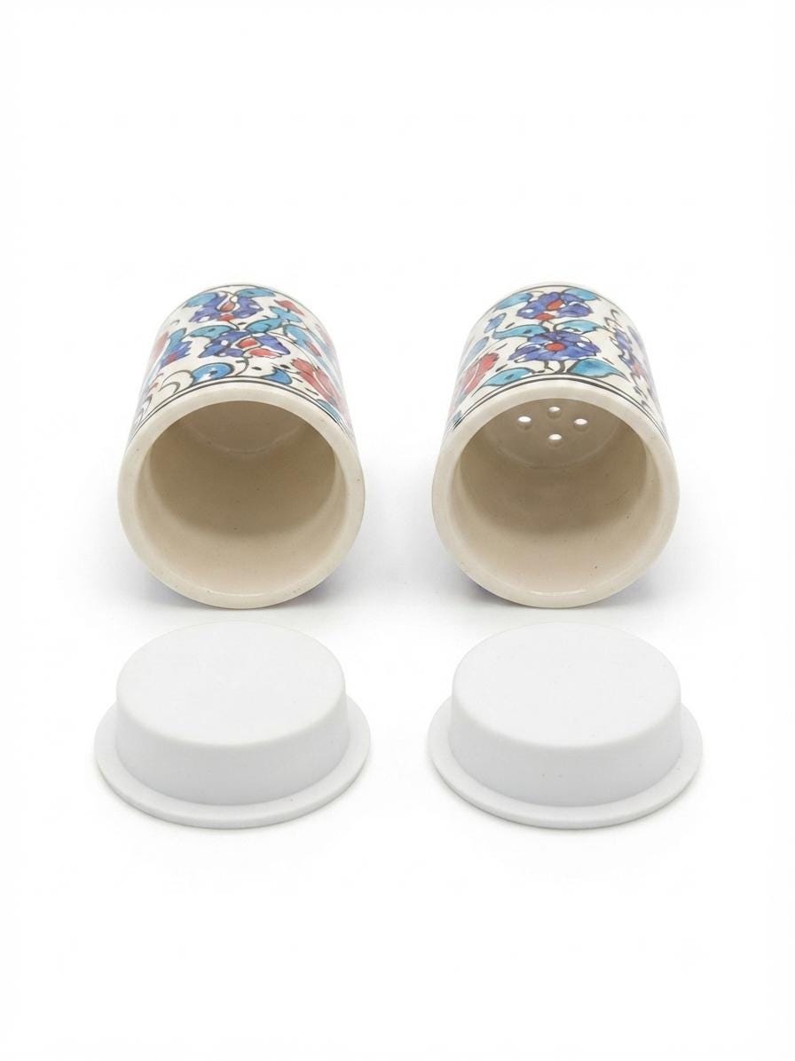 Ceramic salt and pepper shakers with their removable base closures