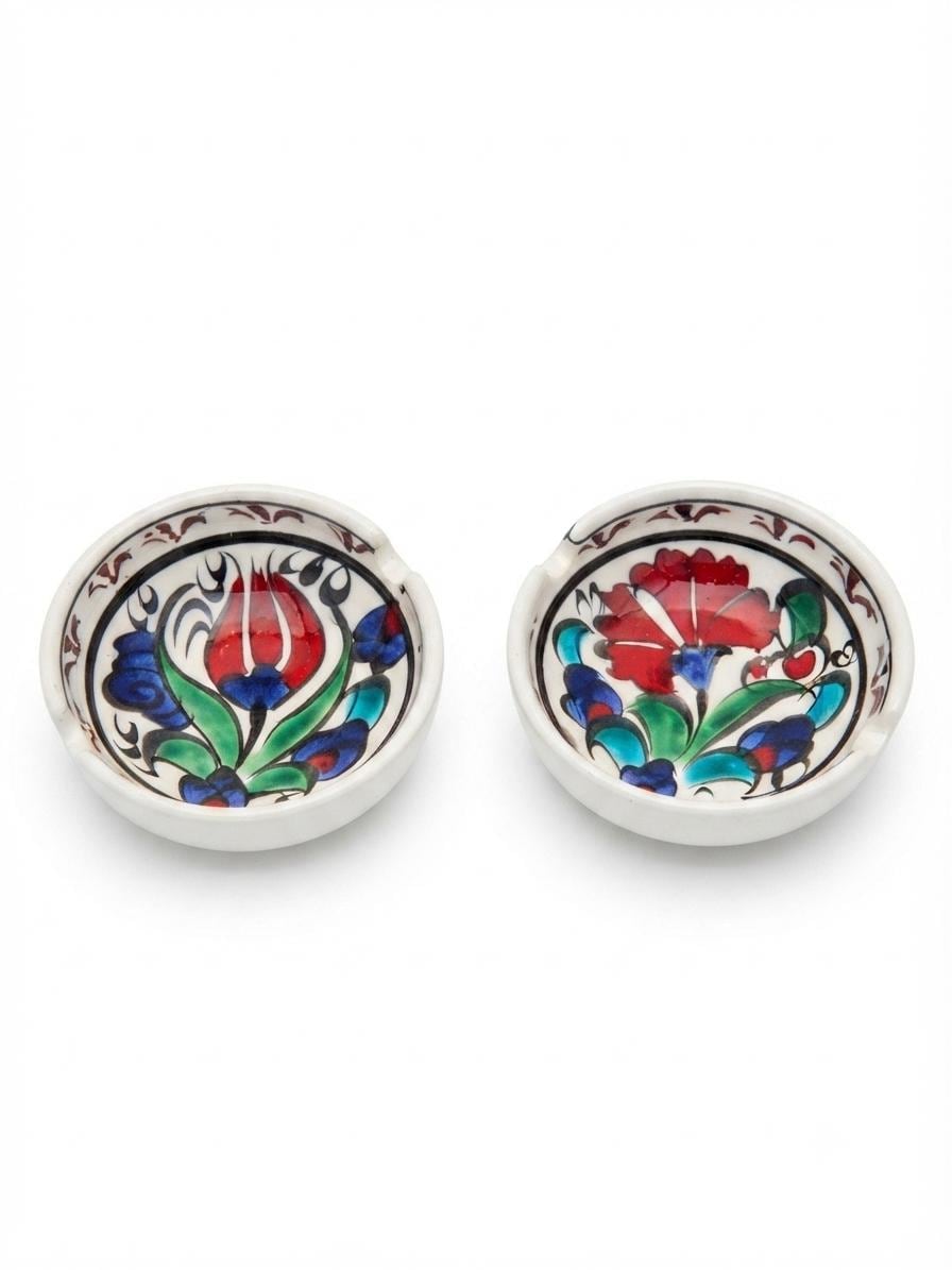 Two floral ceramic ashtrays showing their rim notches