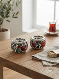 Set of two hand-painted floral ceramic ashtrays