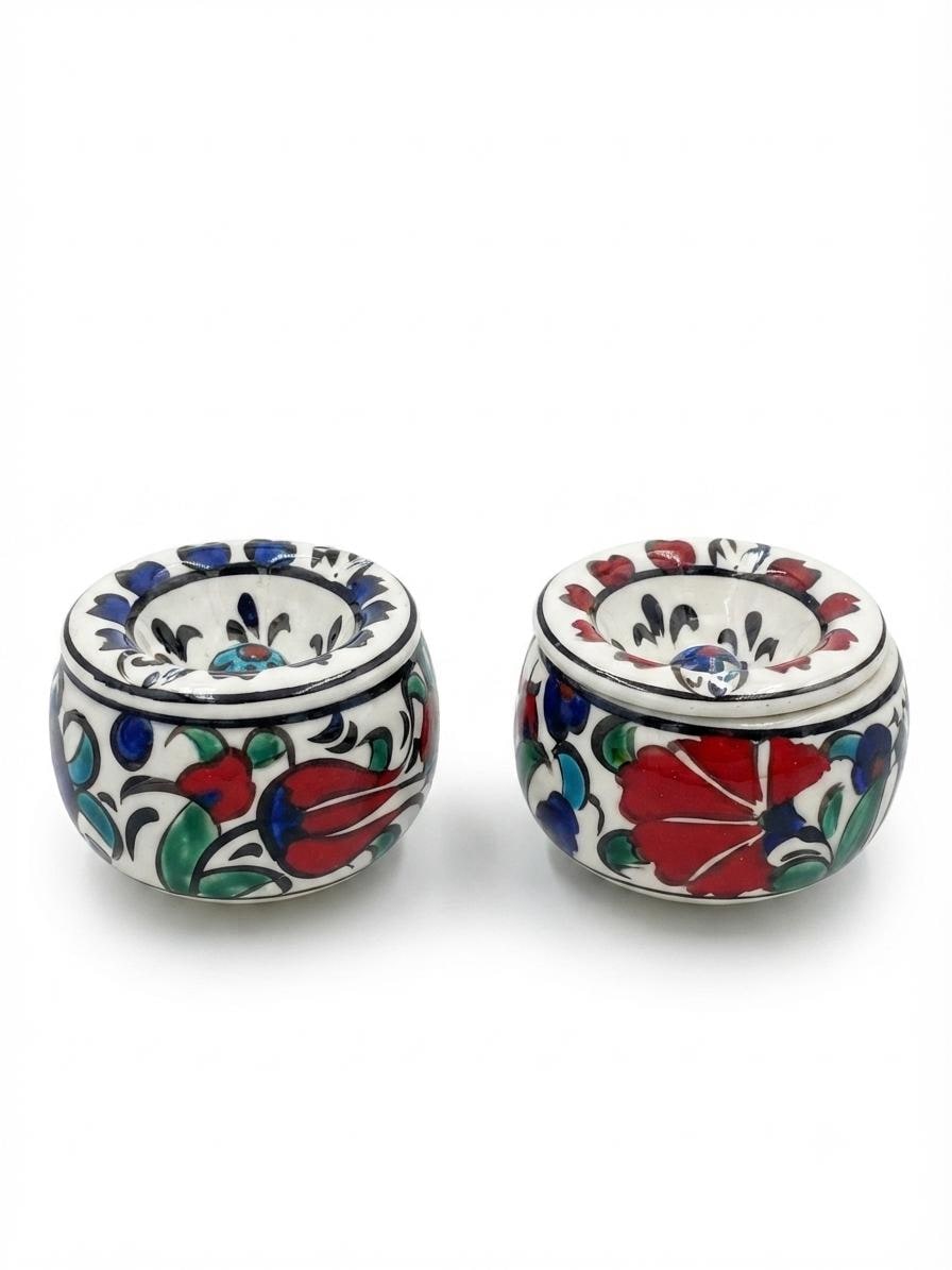 Two hand-painted ceramic ashtrays viewed from above