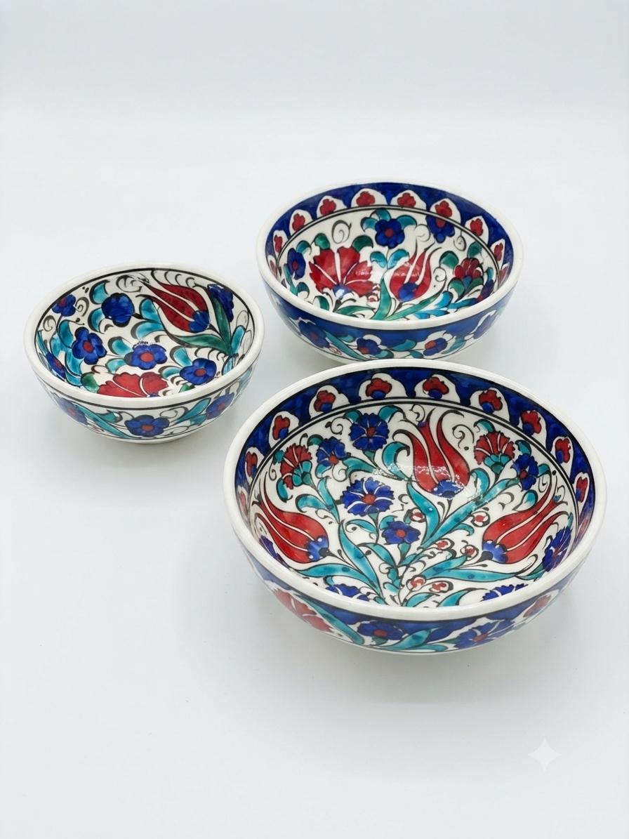 Set of three hand-painted floral ceramic bowls in graduated sizes