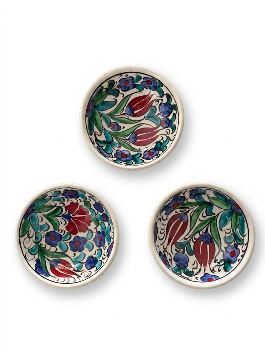 Three hand-painted ceramic bowls showing natural pattern variation