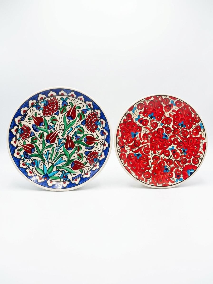 Two hand-painted ceramic serving plates with different floral patterns