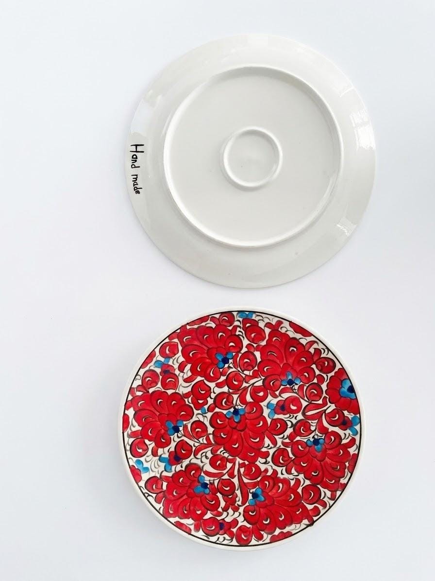 Floral ceramic serving plate with its handmade underside